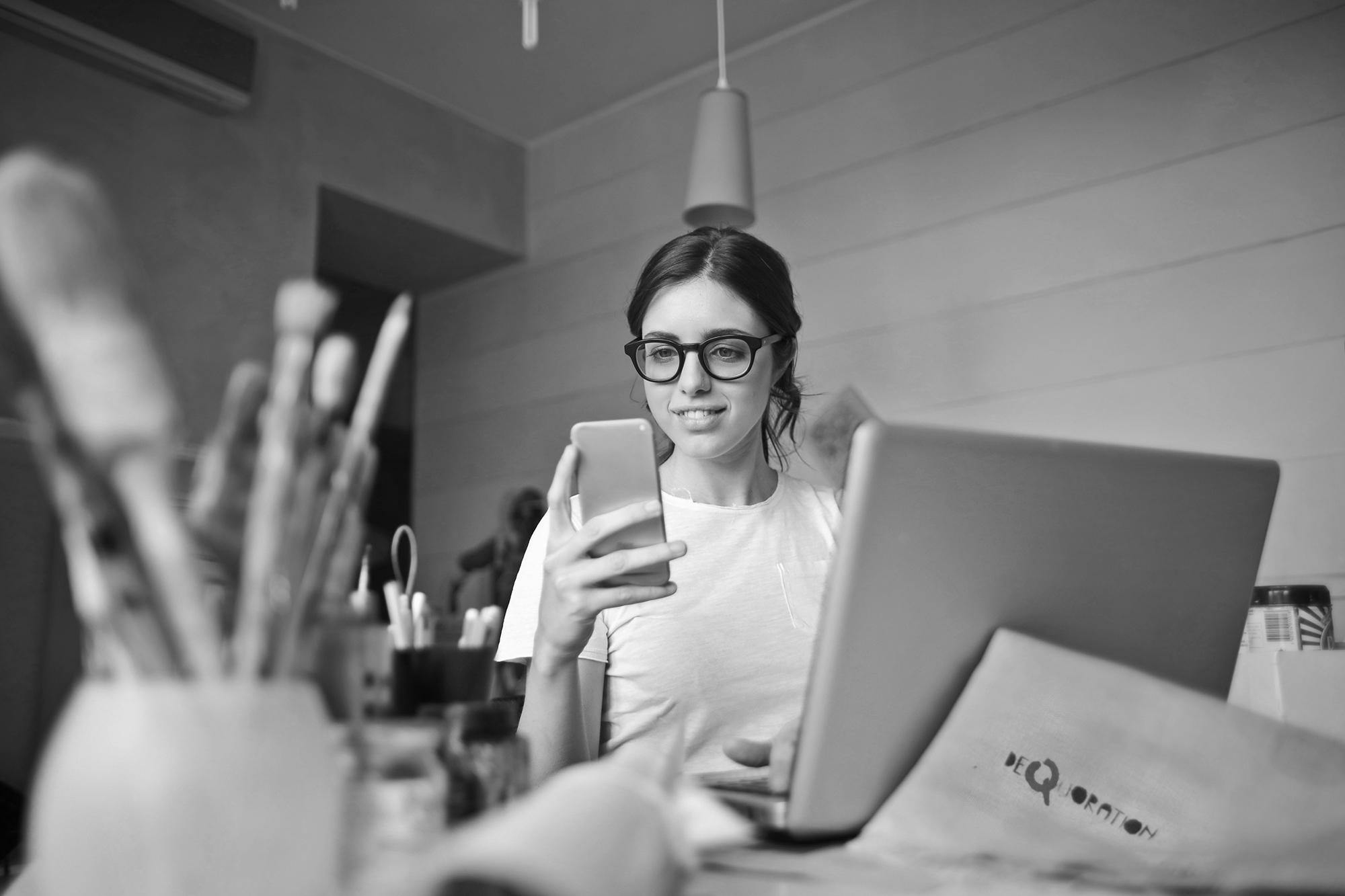 freelancer looking at her phone - learn about pricing and getting paid for freelance work