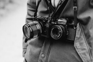 two cameras strapped to one person, one old and one new, Analog vs. Digital Photography