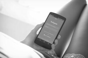 person holding a phone with instagram app open - Best Photography Accounts to Follow on Instagram