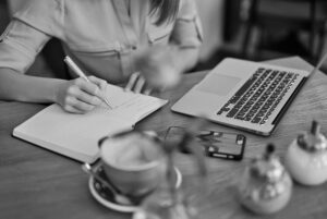 a person writing a list - camera buying checklist