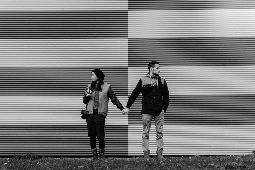 two people standing with each other, looking at opposite directions - learn about conflict and resolution in storytelling
