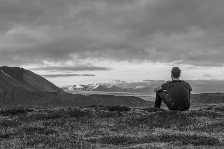 man sitting in nature with foreground and background - Depth in Photography and Video - How to Create Layered Images