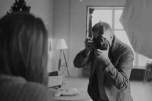 Flash Sync Speed and High-Speed Sync (HSS): What Every Beginner Needs to Know - photographer with camera and flash in studio doing portraits