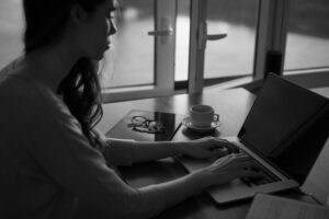 person working with a laptop - Freelance Writer vs Content Agency: Which One Is Right for Your Brand?