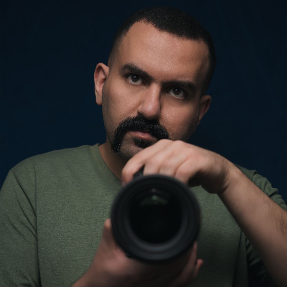 a self portrait of the owner of Hamed Media with a camera in hand