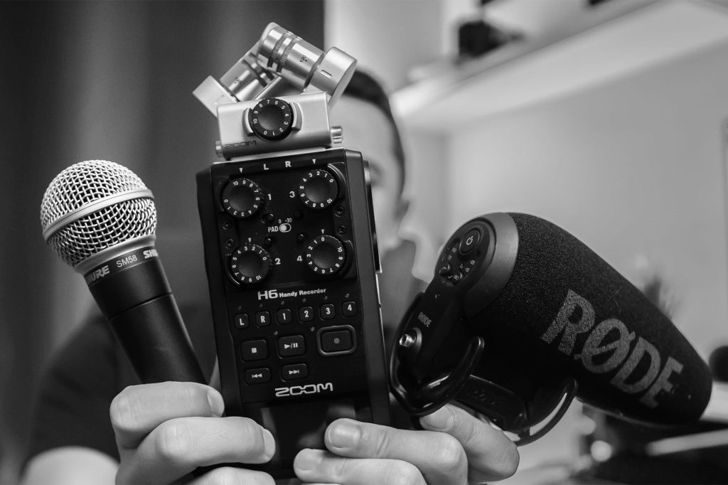 a few microphones and recorders in a person's hand - learn how to choose the best microphone for video