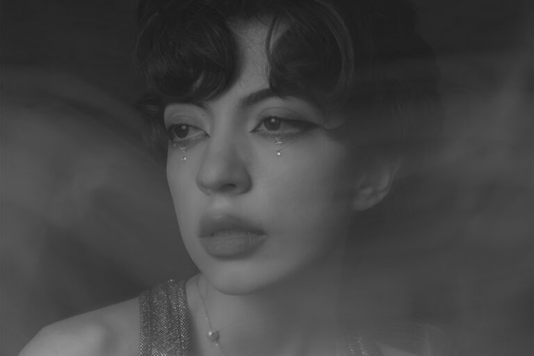 How to Create Light Streak Portraits with Shutter Drag (Step-by-Step Guide) - black and white portrait of a woman with shutter drag technique