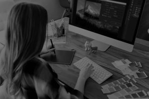 person editing on a computer - learn more about creating a consistent editing style