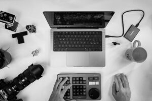 a person editing on a computer - learn how to shoot for the edit