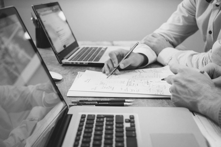 two people with notes and laptops - learn more about storytelling in case studies and testimonials
