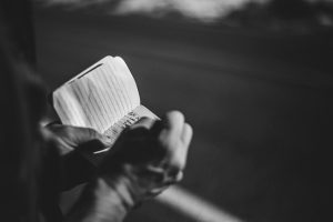 person writing in a notebook - learn more about micro-storytelling or short-form storytelling