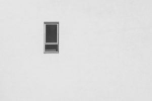 photo of a window and a wall, using the composition technique of negative space