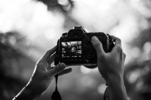 person holding a camera - Learn Practical Composition Exercises to Train Your Eye