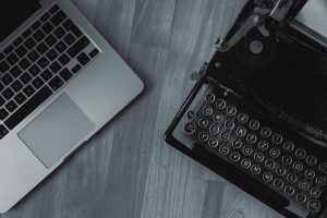 a laptop & a typewriter, a representation for remote writing services or freelance writer for hire