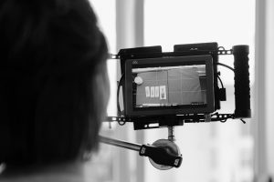 person trying to set a frame using the rule of thirds grid on a camera