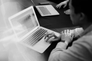 person reading on a laptop - a list of the best art and photography newsletter you can subscribe to