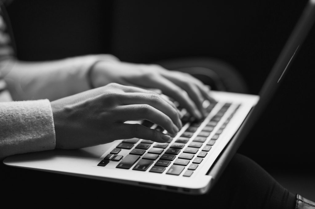 person writing on a laptop - What Does a Content Writer Actually Do?