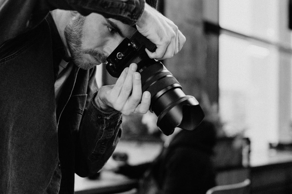 person taking a photo - What to Expect When You Hire a Photographer