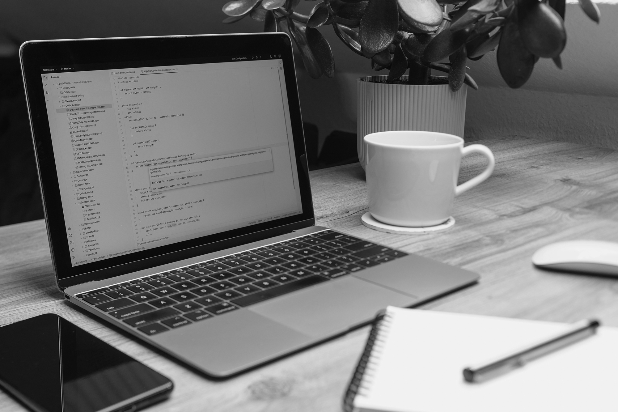 Why I Chose Hostinger for My Website (And Why I Stayed) - laptop on a table with cup, notepad and phone