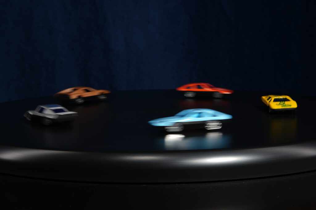 some toy cars on a lazy susan: moving subject with slow shutter speed